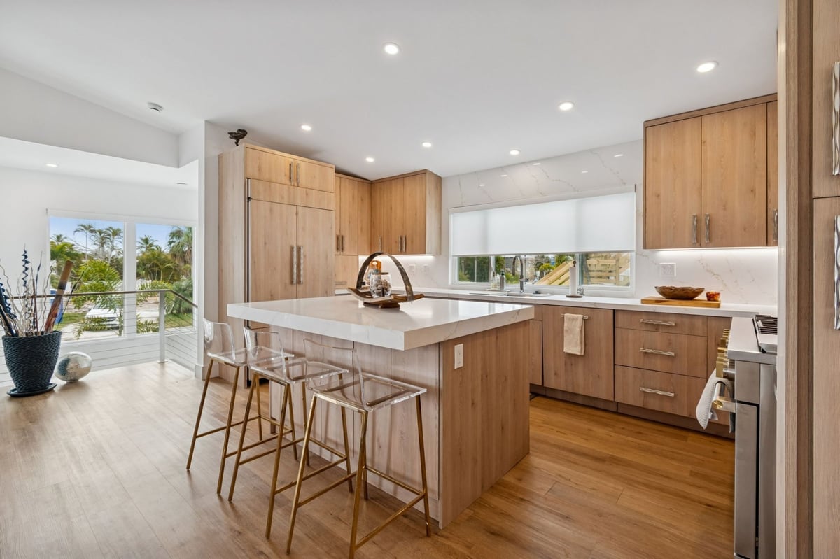 Interior Kitchen Island Quartz Countertop Bar Stools Wood Cabinets