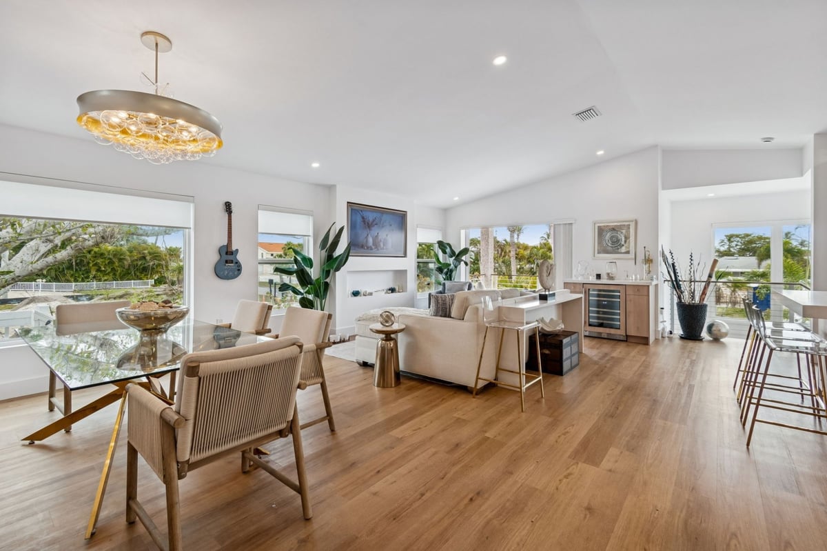 Interior Open Concept Living Dining Room Chandelier Wood Floors Coastal Views