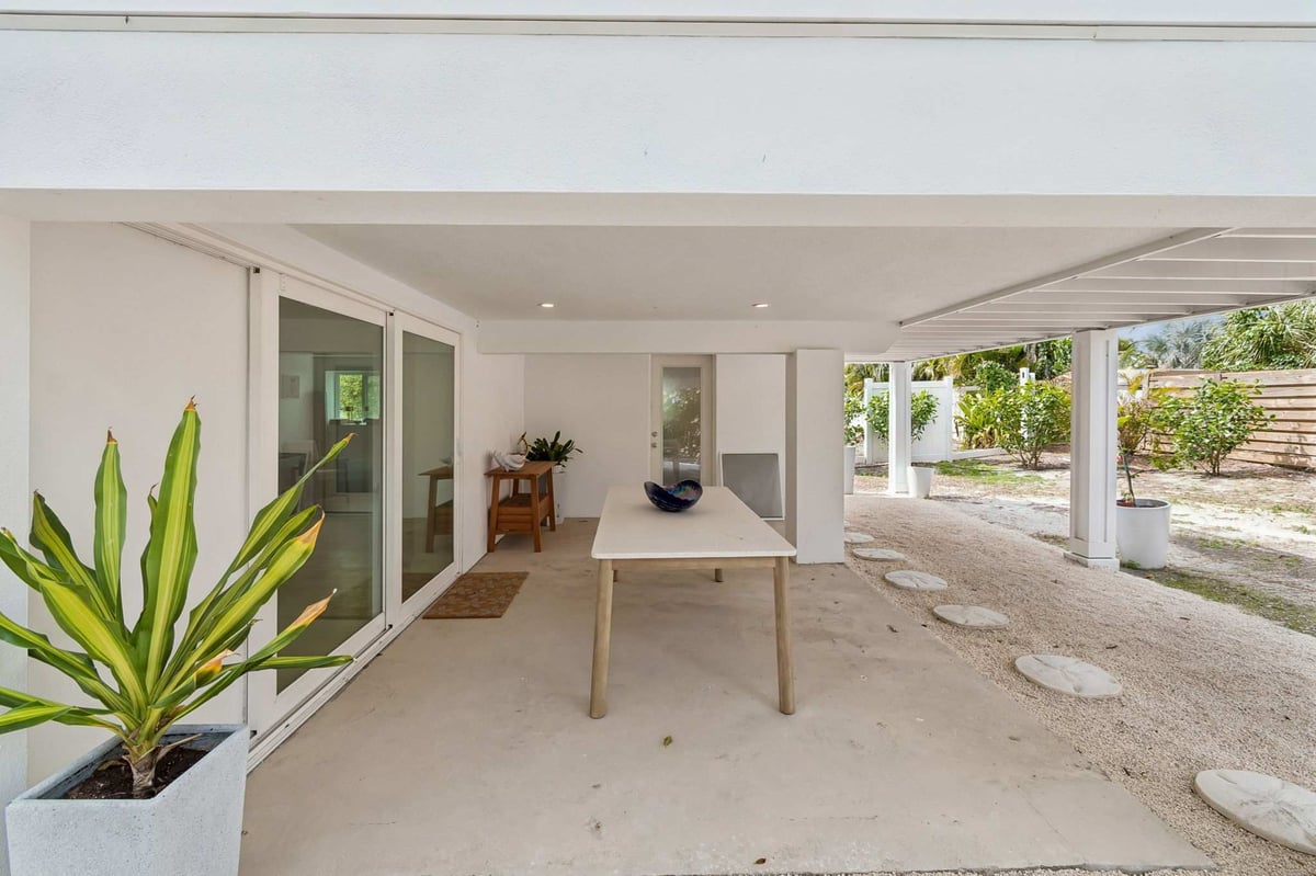 longboat key new home covered patio outdoor dining sliding doors