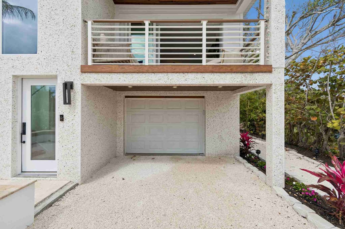 longboat key new home garage door balcony gravel driveway