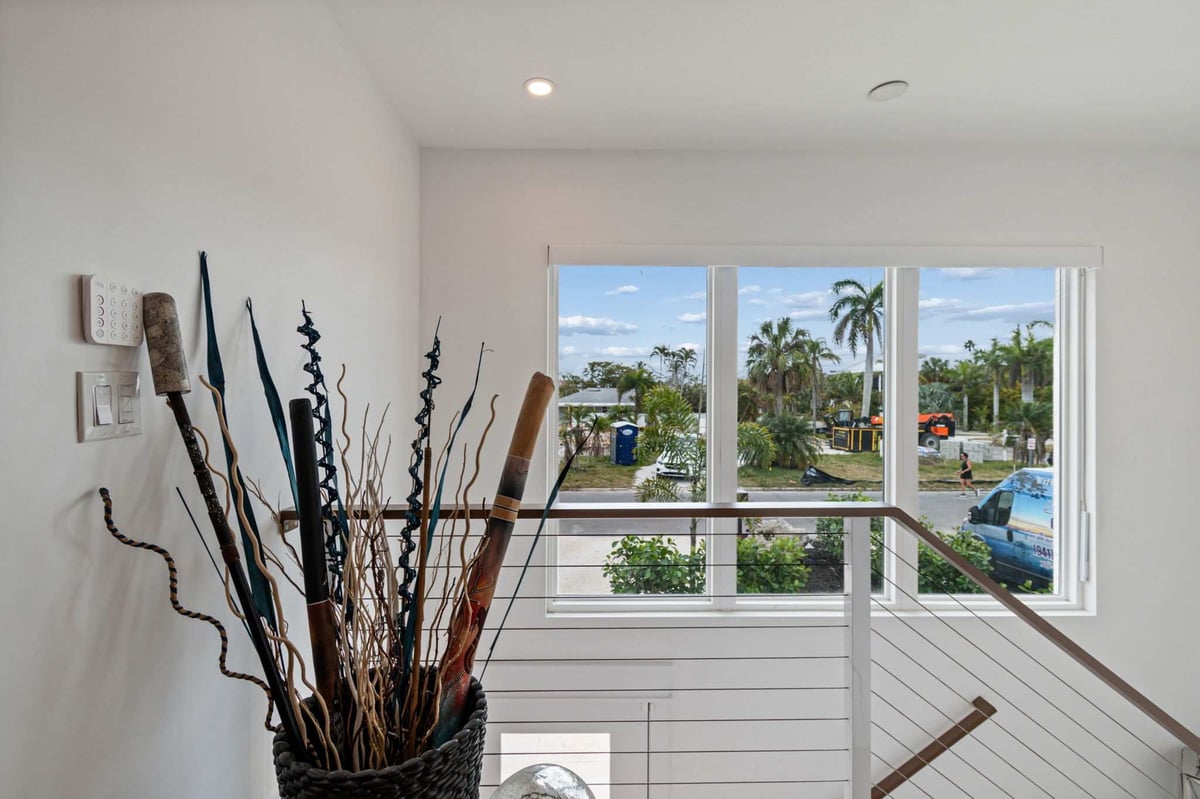 longboat key new home interior staircase landing window palm tree view